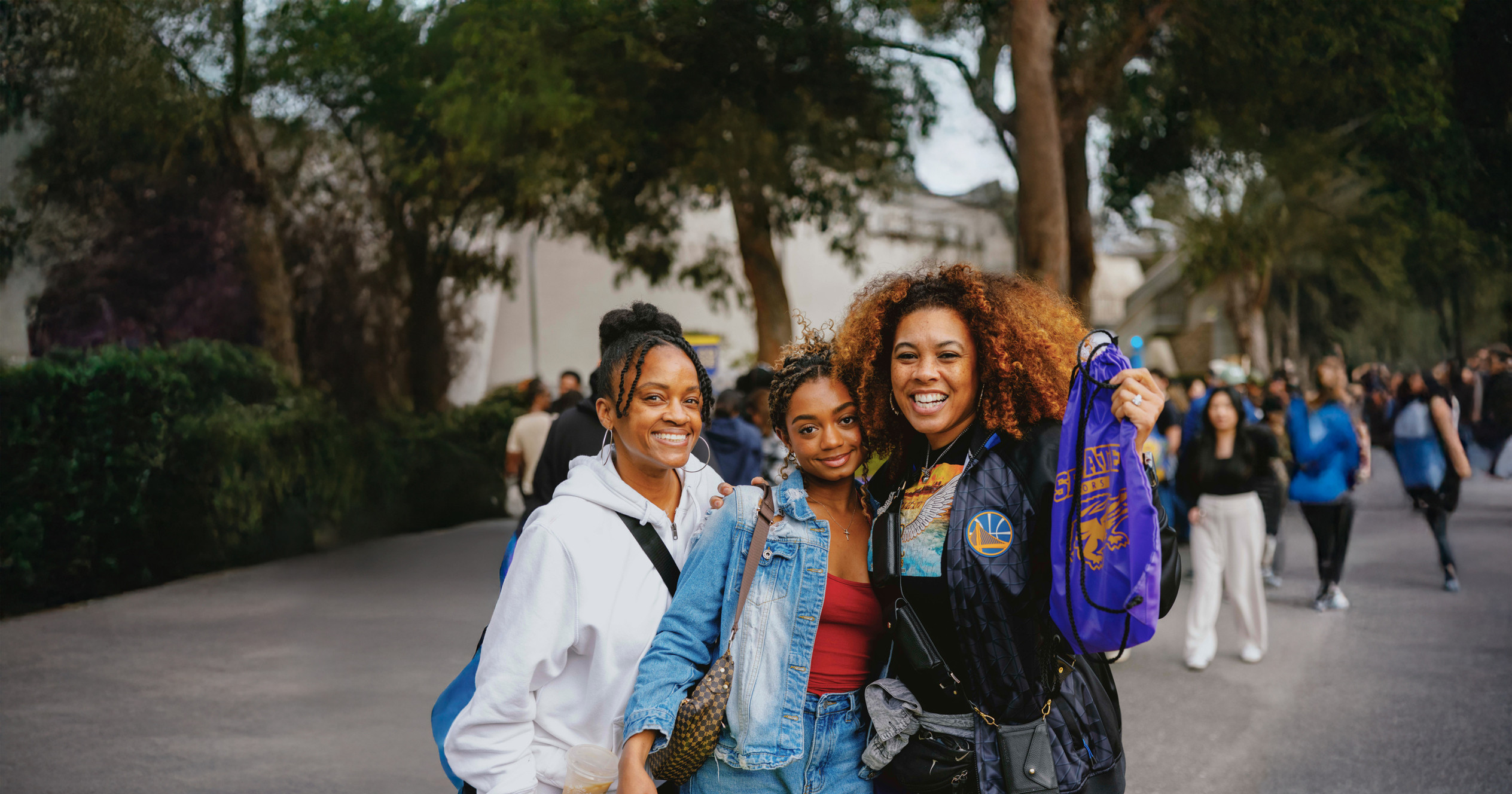 Three Women posing with SFSU Swag