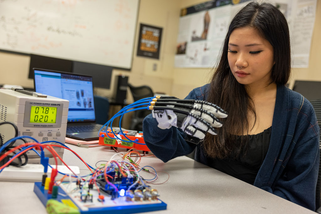 Female student testing out robotic hand