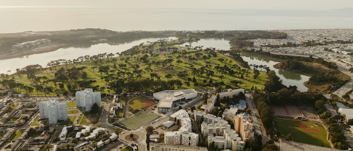 Ariel view of campus, palm trees, lake and ocean