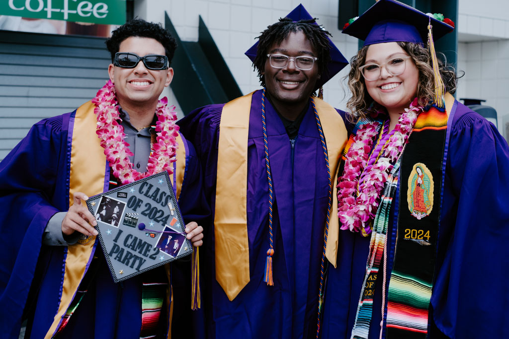 Three students celebrating at commencement